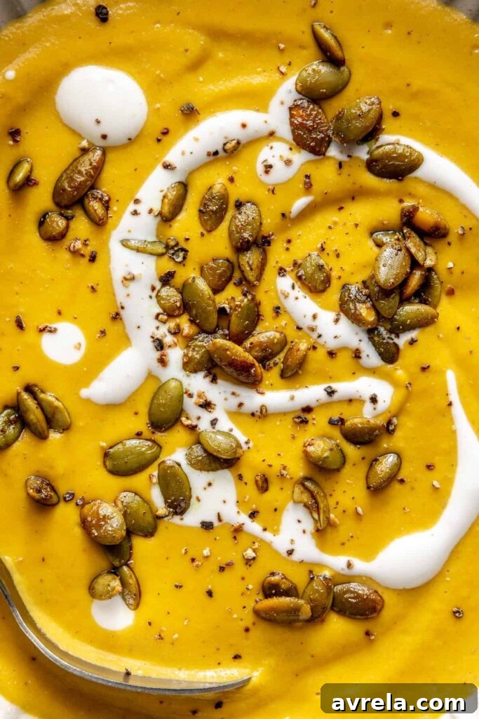 Kabocha cashew curry soup served with pumpkin seed topping – gluten-free, dairy-free recipe