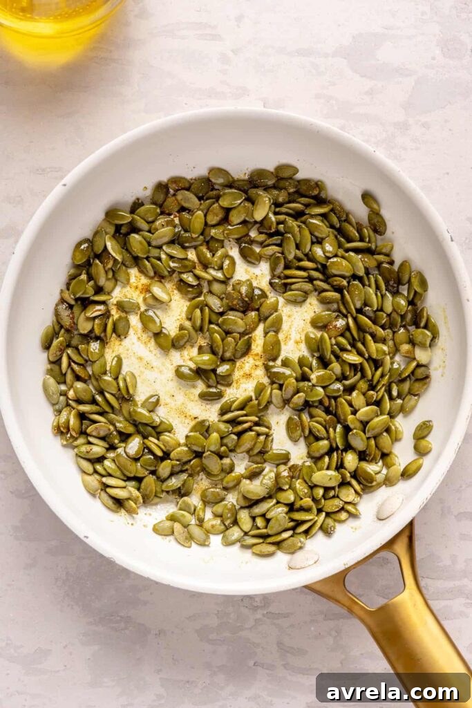Kabocha cashew curry soup served with pumpkin seed topping – gluten-free, dairy-free recipe