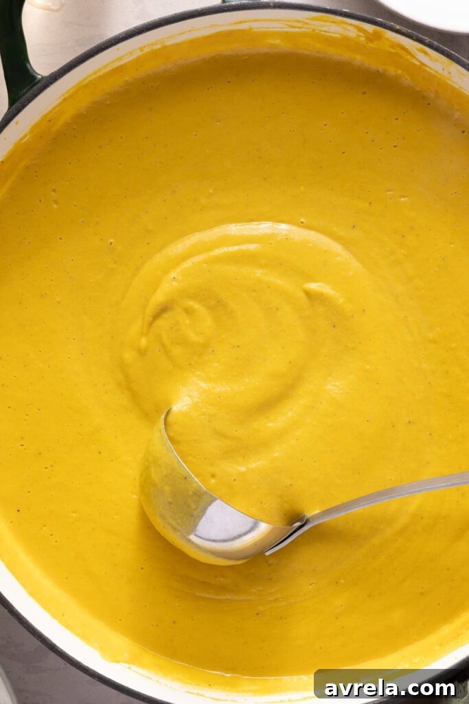Kabocha cashew curry soup served with pumpkin seed topping – gluten-free, dairy-free recipe