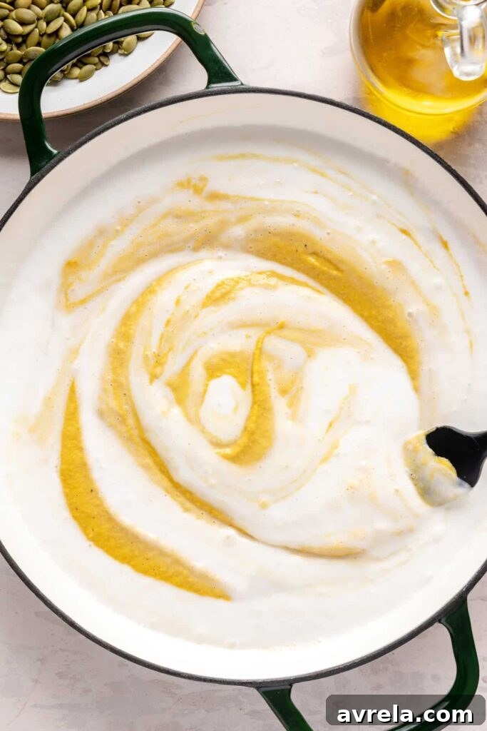 Kabocha cashew curry soup served with pumpkin seed topping – gluten-free, dairy-free recipe