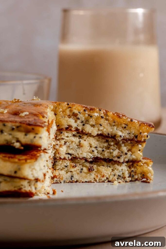 Healthy, gluten-free and dairy-free lemon poppyseed protein pancakes stacked on a plate