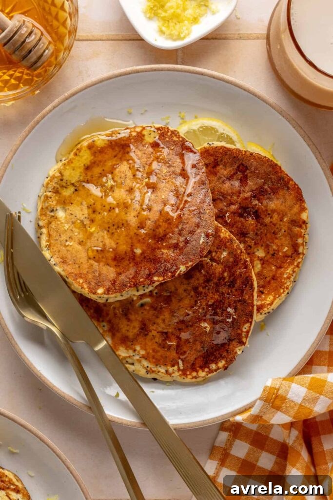 Healthy, gluten-free and dairy-free lemon poppyseed protein pancakes stacked on a plate