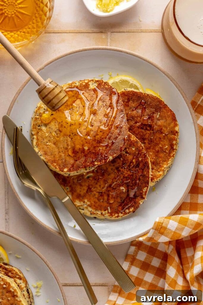 Healthy, gluten-free and dairy-free lemon poppyseed protein pancakes stacked on a plate