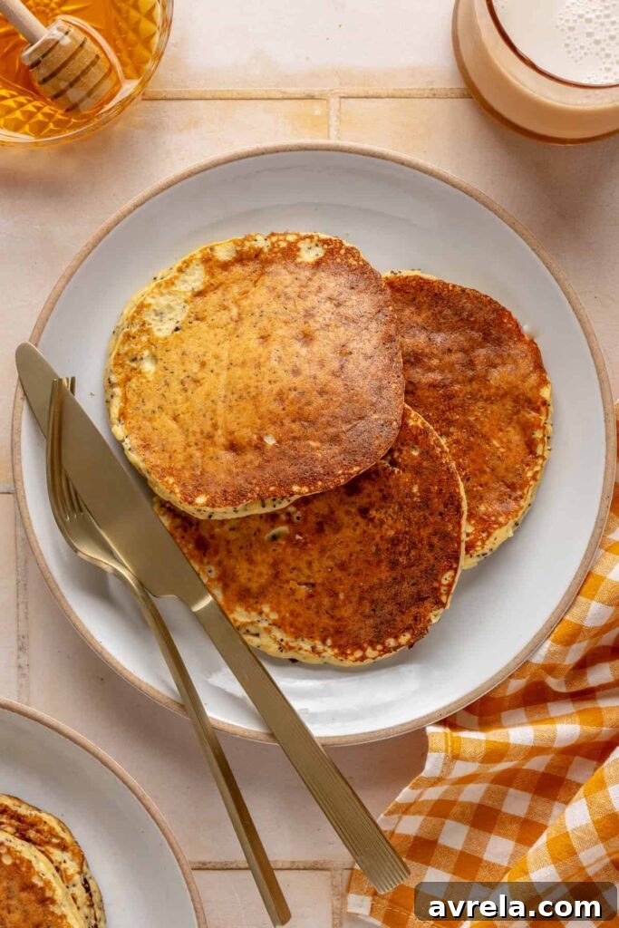 Healthy, gluten-free and dairy-free lemon poppyseed protein pancakes stacked on a plate
