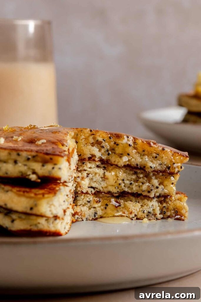Healthy, gluten-free and dairy-free lemon poppyseed protein pancakes stacked on a plate