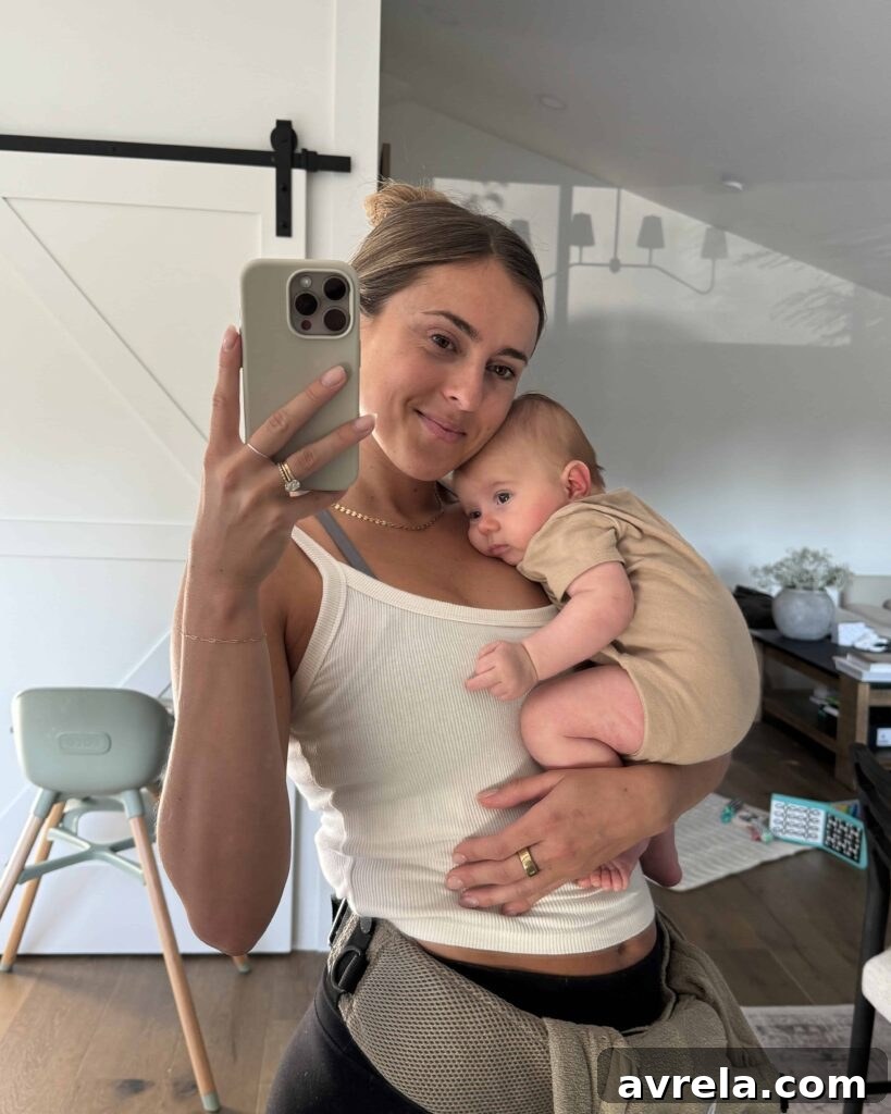 First-time mom holding baby with big smile