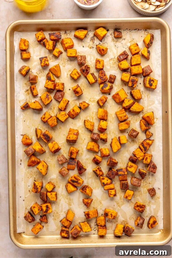 Maple-Roasted Sweet Potatoes with Whipped Feta and Hot Honey 12 Golden roasted sweet potato cubes with crispy edges on a baking sheet