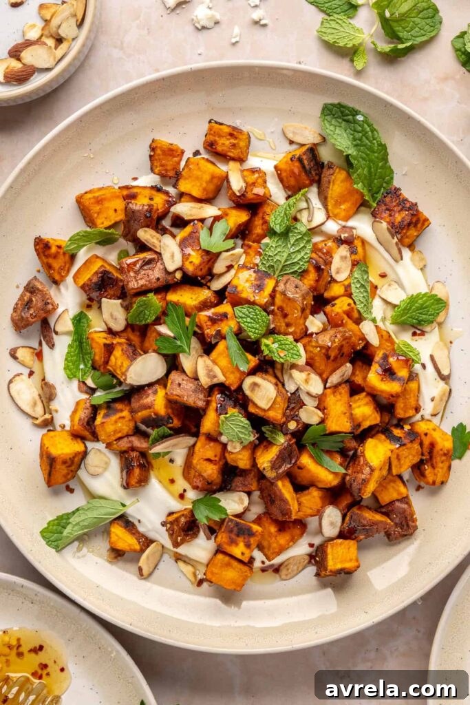 Maple-Roasted Sweet Potatoes with Whipped Feta and Hot Honey 3 Plated roasted sweet potatoes over creamy whipped feta topped with hot honey, and fresh herbs