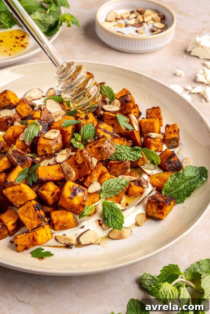Maple-Roasted Sweet Potatoes with Whipped Feta and Hot Honey 5 Drizzling hot honey over roasted sweet potatoes with whipped feta and fresh herbs