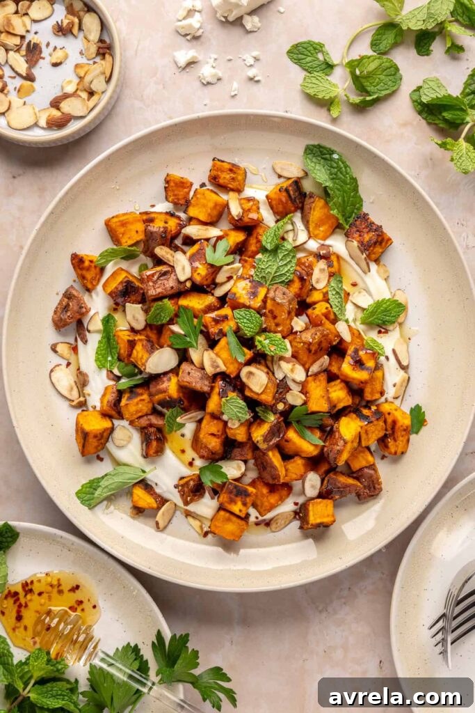 Maple-Roasted Sweet Potatoes with Whipped Feta and Hot Honey 7 Plated roasted sweet potatoes over creamy whipped feta topped with hot honey, and fresh herbs