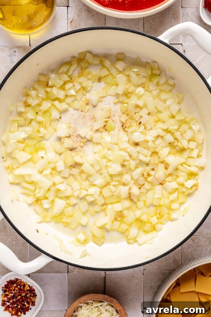 High-Protein Lasagna Soup Recipe — Easy, Hearty & Protein-Packed 9 sautéing aromatic ingredients for lasagna soup including onions and garlic