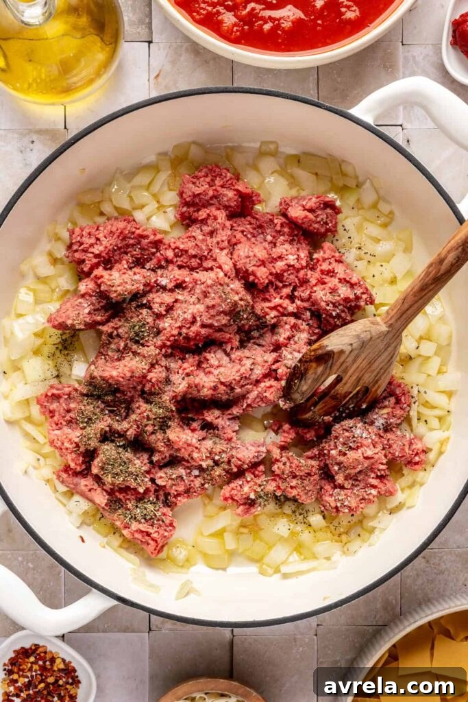 High-Protein Lasagna Soup Recipe — Easy, Hearty & Protein-Packed 10 browning the ground beef with the sautéed aromatics for lasagna soup including onions and garlic