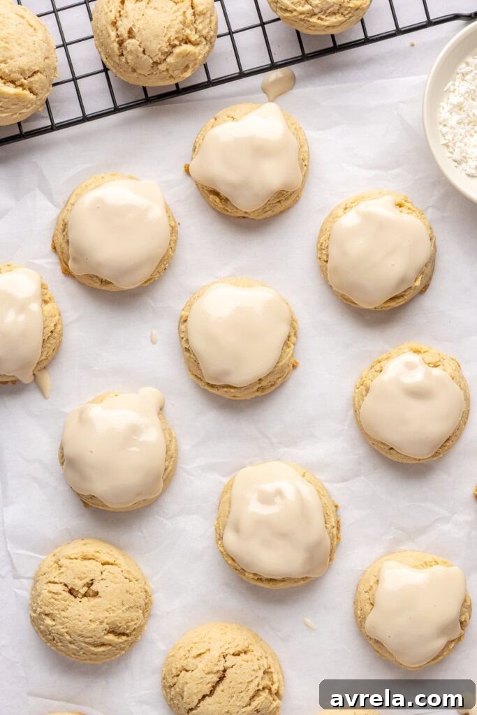 iced Christmas Sugar Cookies on parchment paper and a baking sheet