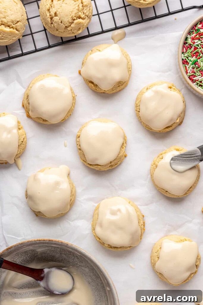 adding icing to Christmas Sugar Cookies