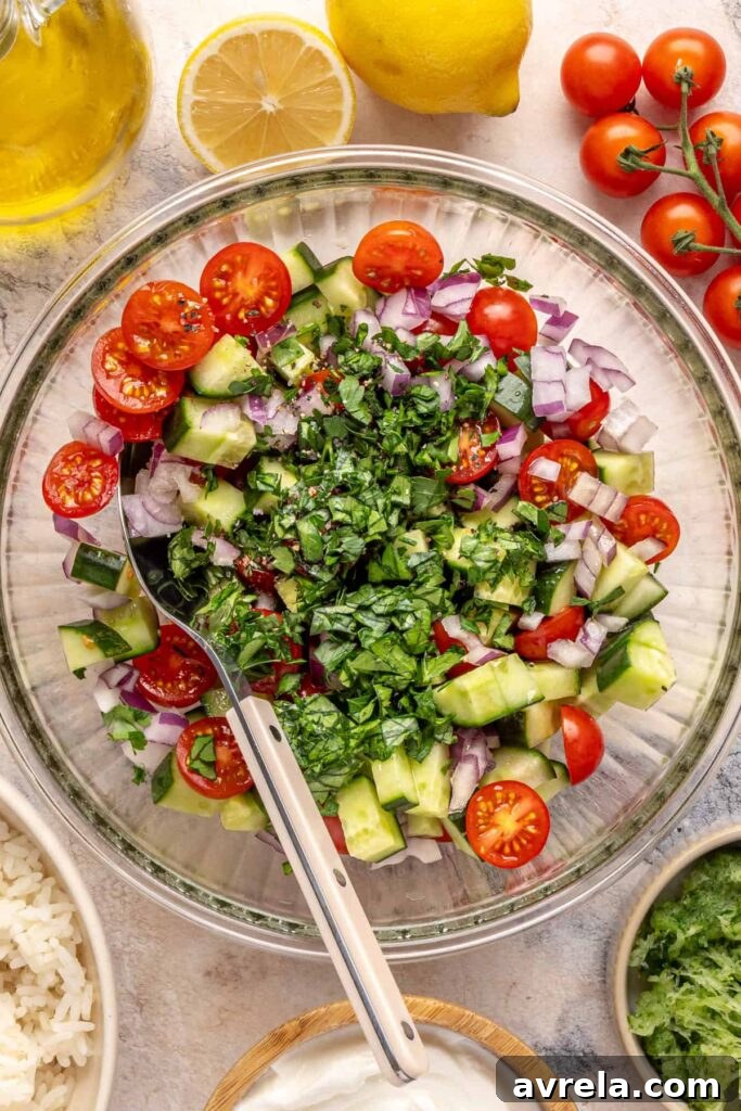 Chopped cucumber, cherry tomatoes, red onion, and fresh dill for Greek cucumber salad.