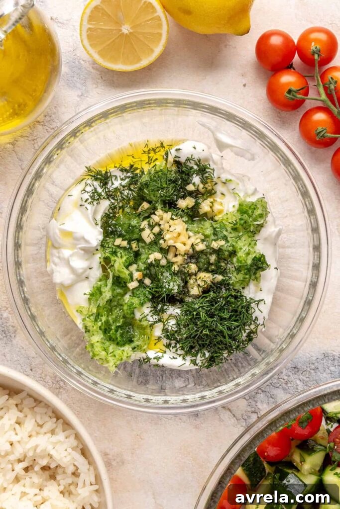 Greek yogurt, grated cucumber, garlic, dill, and lemon assembled for homemade tzatziki.