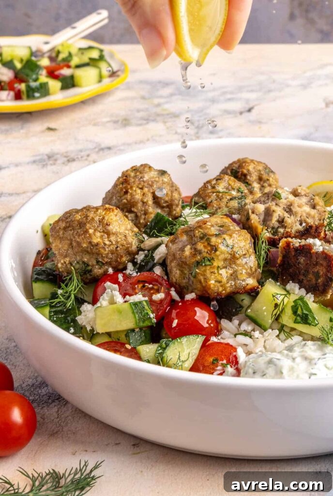 squeezing fresh lemon juice over juicy Greek turkey meatballs served over rice with tzatziki and cucumber-tomato salad.