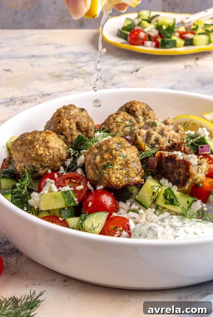 squeezing fresh lemon juice over juicy Greek turkey meatballs served over rice with tzatziki and cucumber-tomato salad.