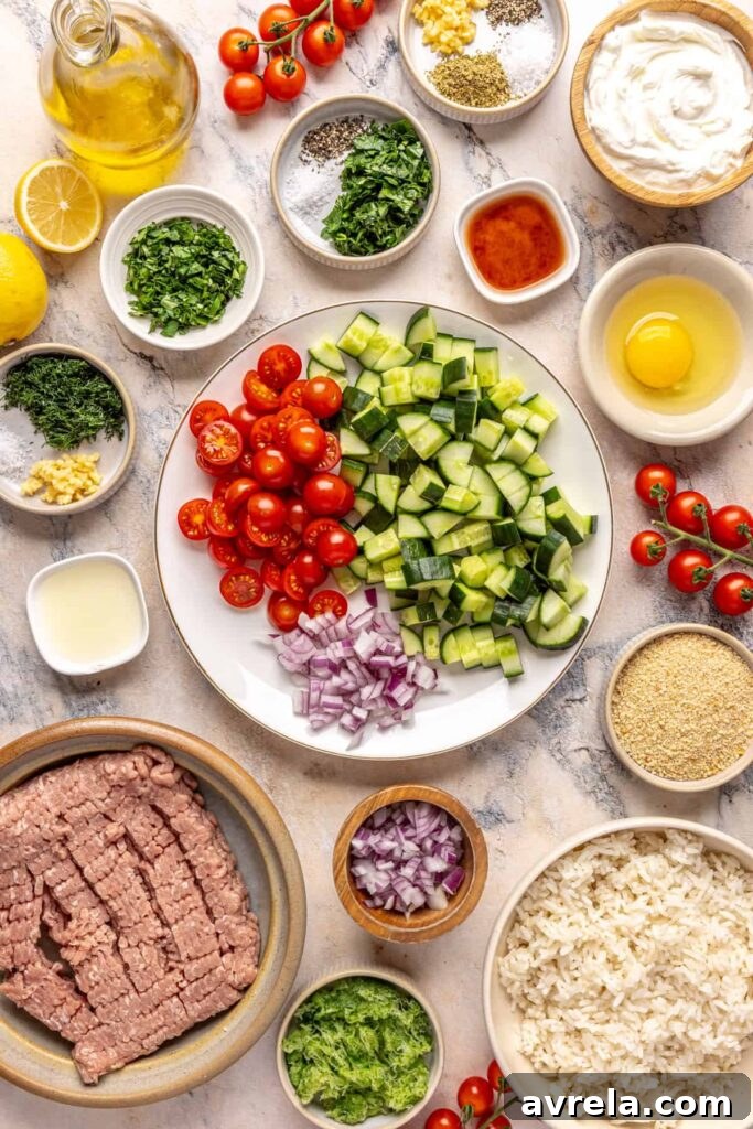 Ingredients for Greek turkey meatballs with cucumber salad and tzatziki arranged on a countertop.