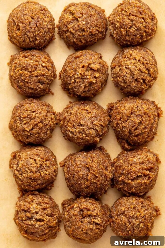 Unchilled gingerbread protein balls on parchment paper ready to set