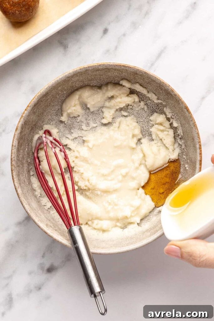 mixing melted coconut butter with maple syrup for drizzling over gingerbread protein balls