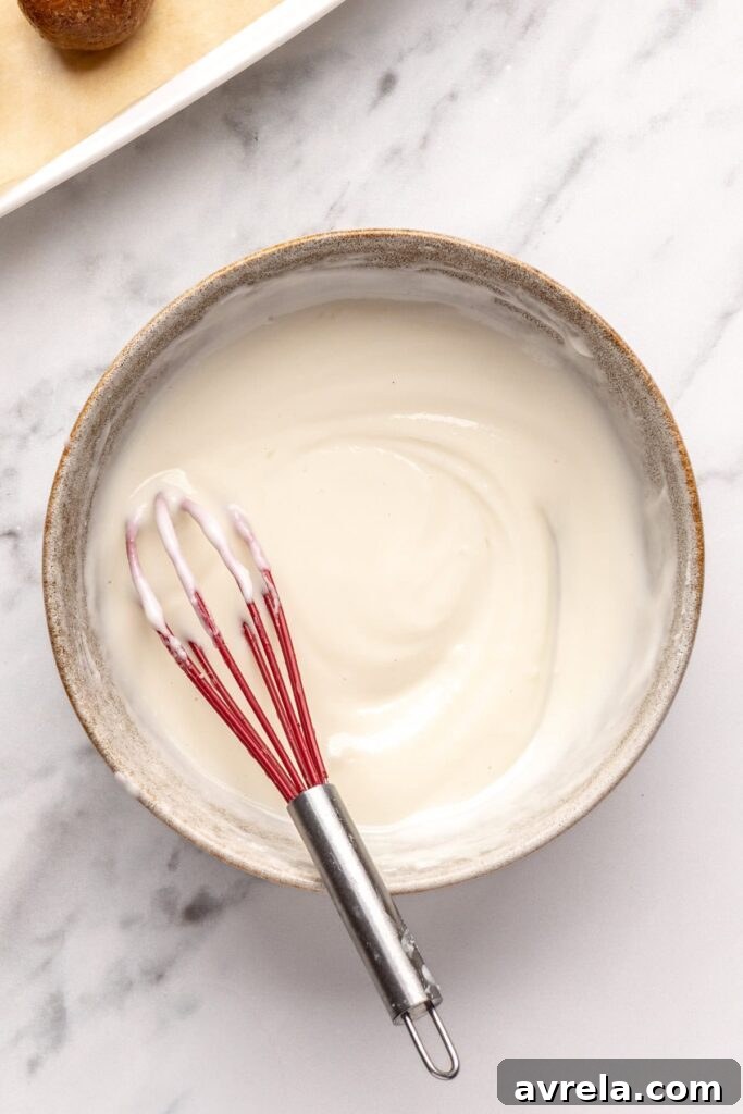 Melted coconut butter with maple syrup for drizzling over gingerbread protein balls