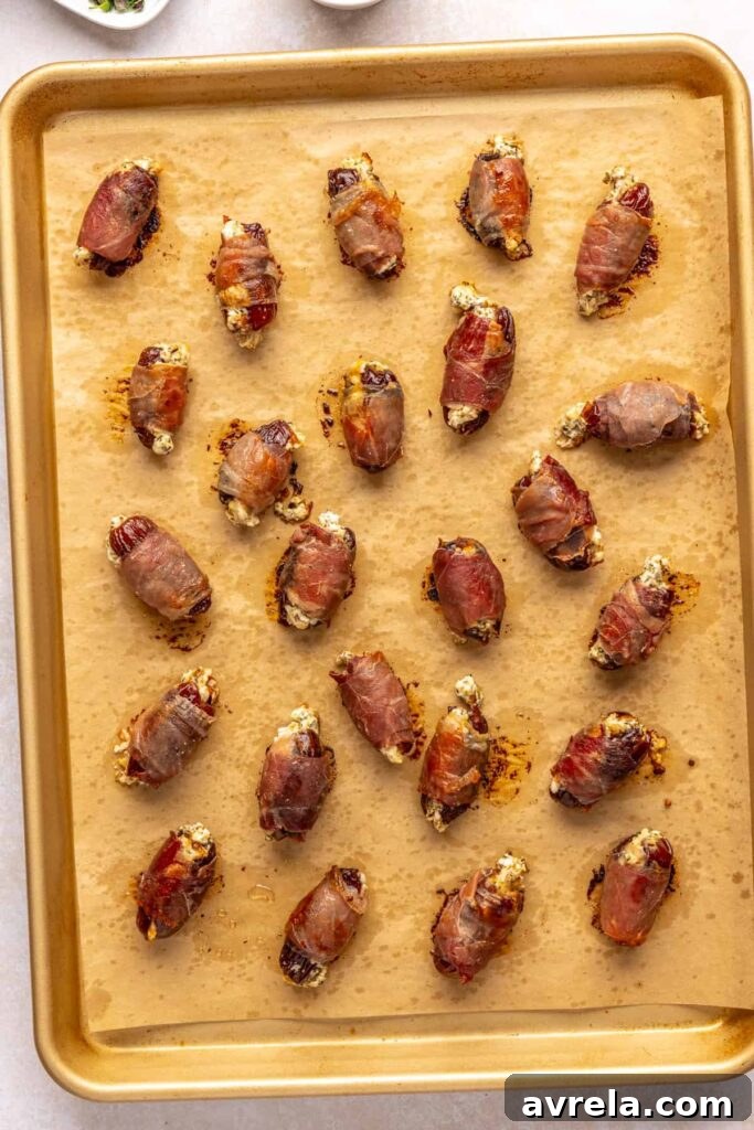 Baked prosciutto stuffed dates with goat cheese filling cooling before serving