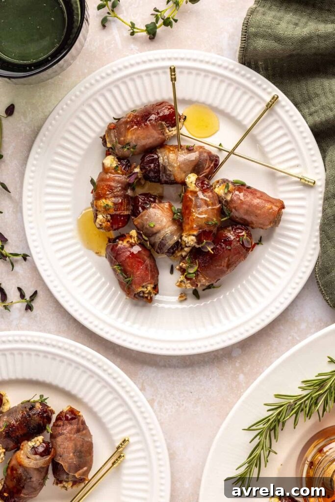 Individual prosciutto wrapped stuffed dates with goat cheese filling, on toothpicks, on a plate