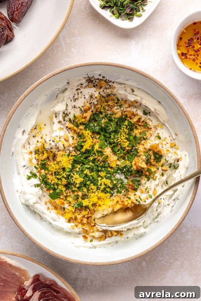 Overhead view of herbed goat cheese, lemon, walnuts, and parsley ready to make stuffed dates filling