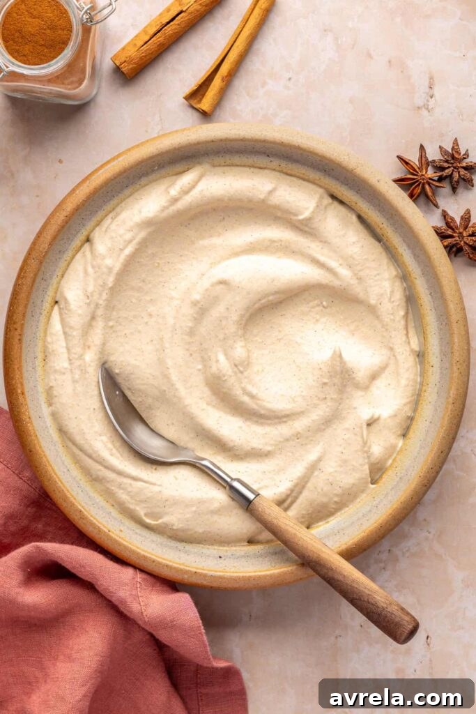 Fluffy pumpkin cold foam in a bowl with a spoon for serving