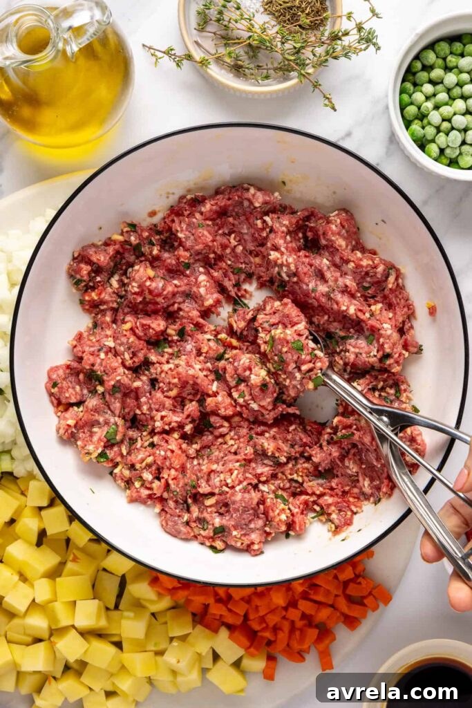 Scooping seasoned beef meatballs for meatball soup