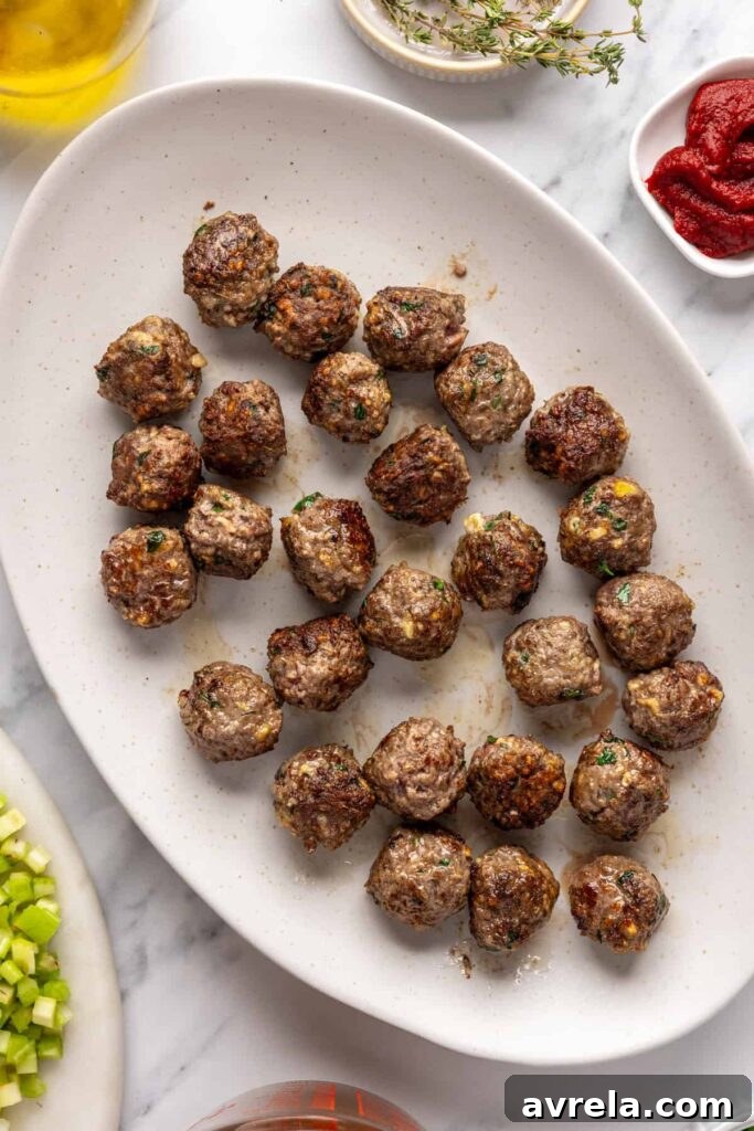 cooked beef meatballs on a plate, waiting to be added into the soup