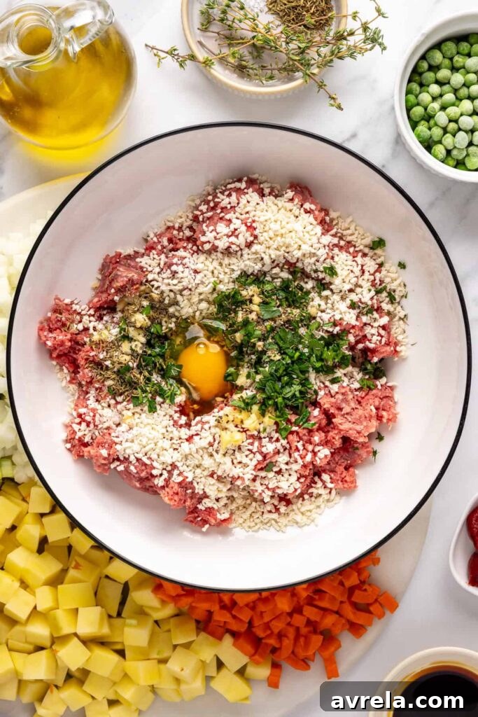ground beef, panko, egg, garlic, and herbs for beef meatballs in a bowl