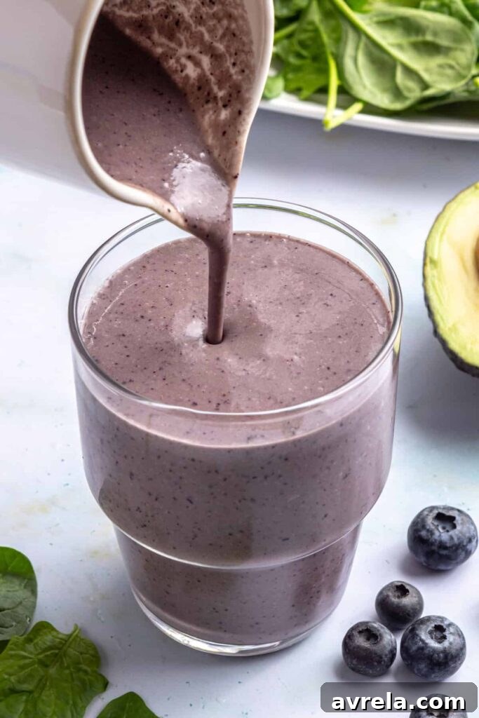 Toddler Smoothie Recipes: Nutritious, Filling & Naturally Sweetened 9 Pouring freshly blended toddler smoothie into a glass