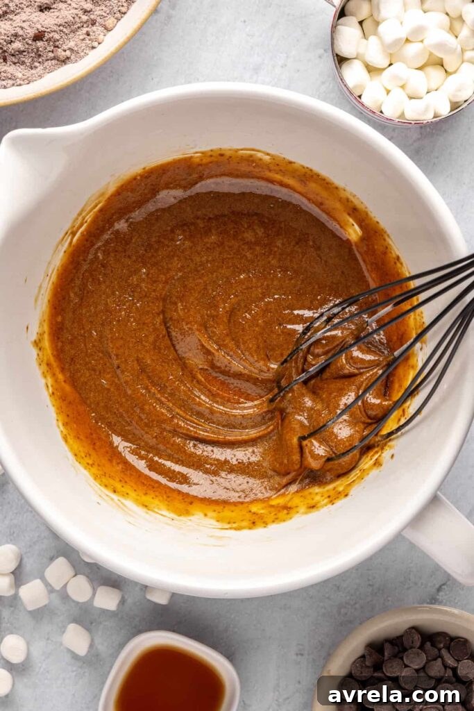 Whisking eggs, coconut sugar, and avocado oil for hot cocoa cookies