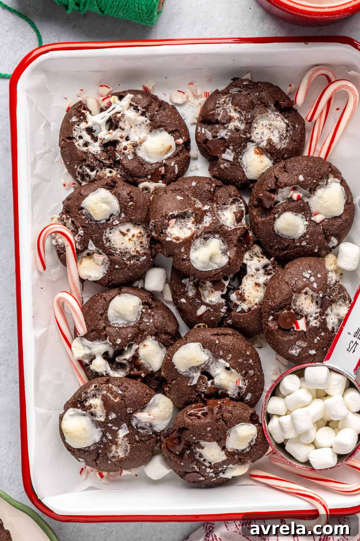 Holiday hot cocoa cookies arranged with candy canes on a festive tray