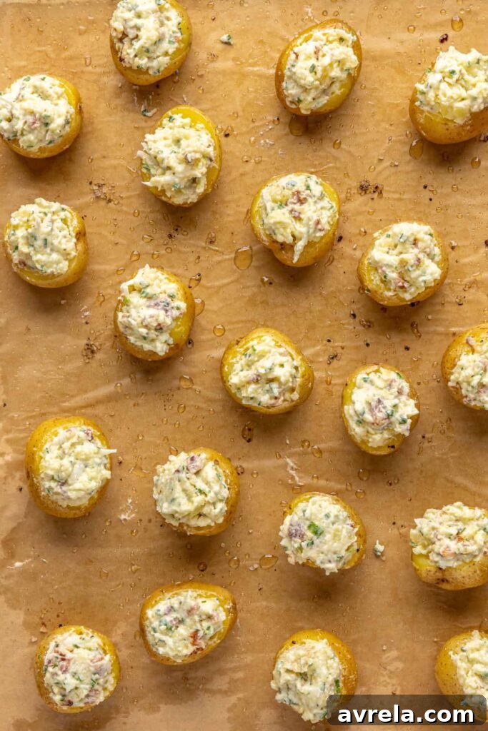 Filling being spooned into baked potato shells