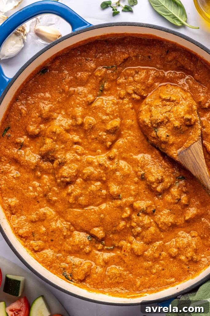 Finished high-protein vodka sauce in a large pot, overhead shot with wooden spoon