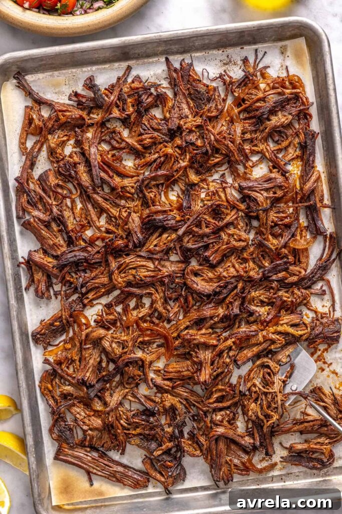 Shredded Greek beef broiled until crispy on a parchment-lined sheet pan