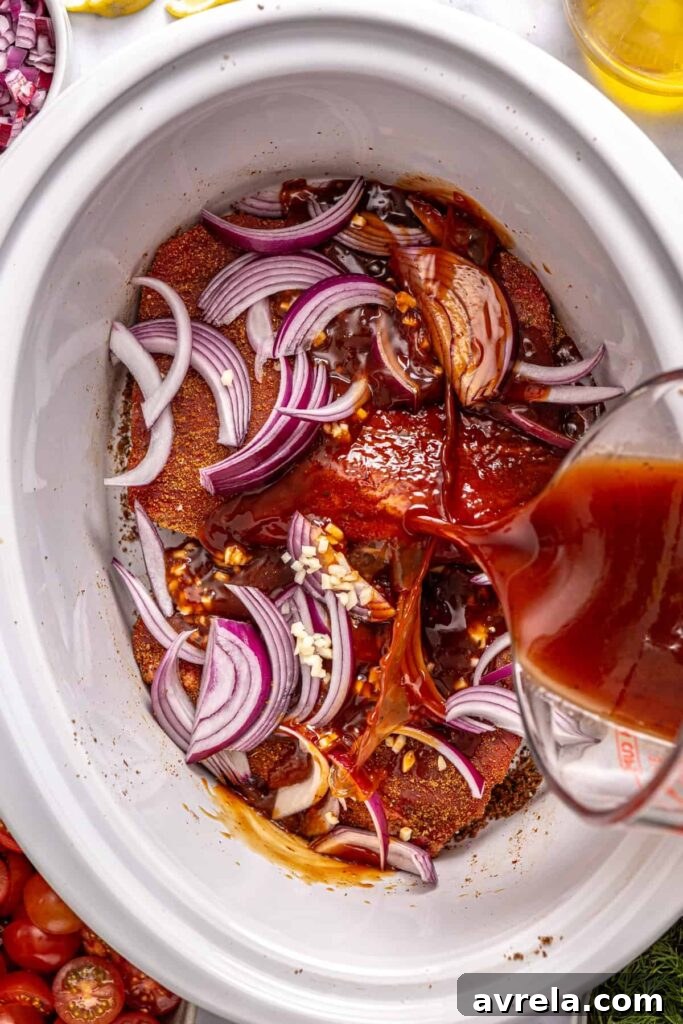 Greek braising sauce poured over seasoned flank steak in a crock-pot