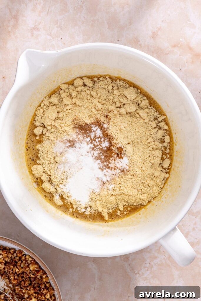 Coffee cake muffin batter being mixed until smooth with almond flour and cinnamon