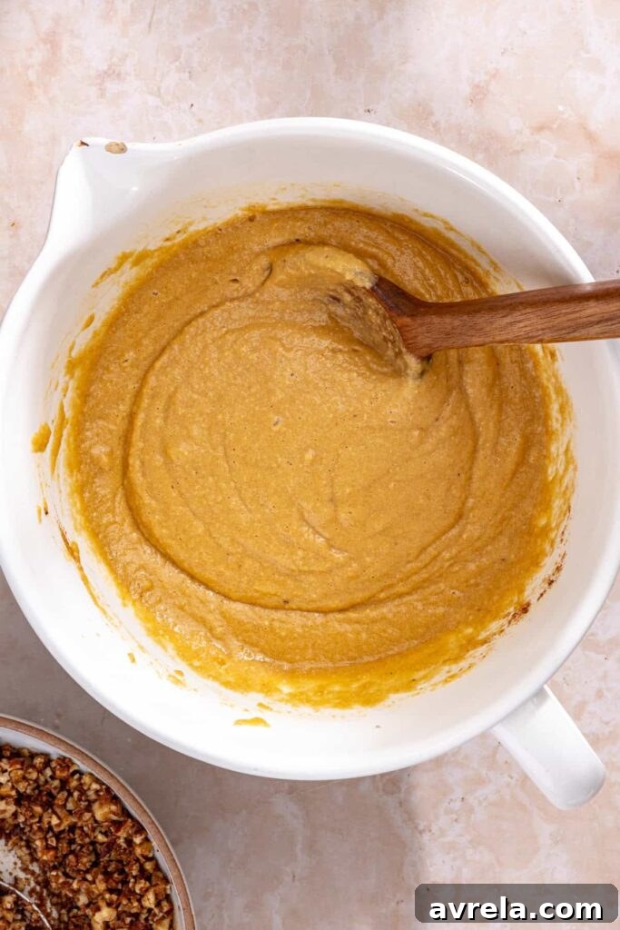 Stirring almond flour and baking powder into coffee cake muffin batter