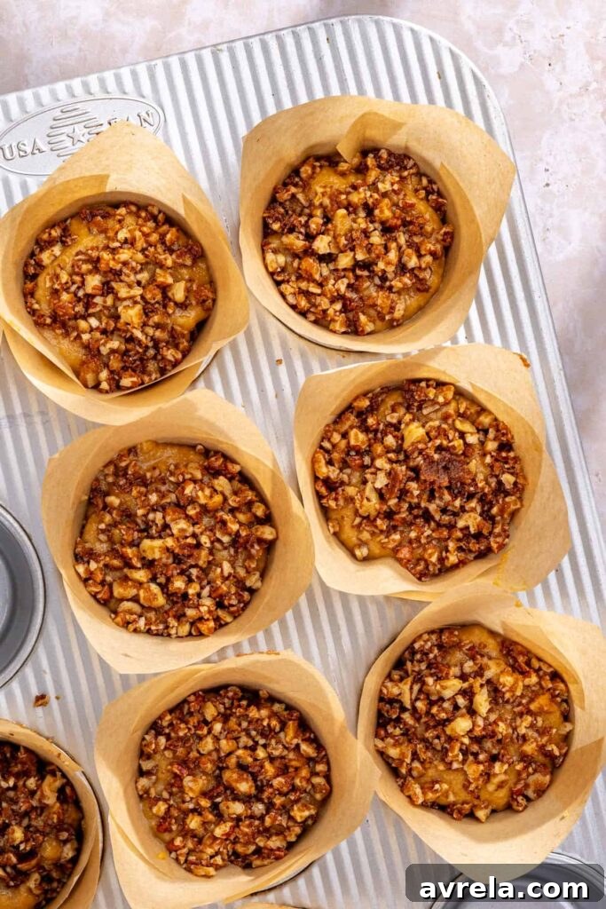 Unbaked coffee cake muffins topped with pecan walnut streusel