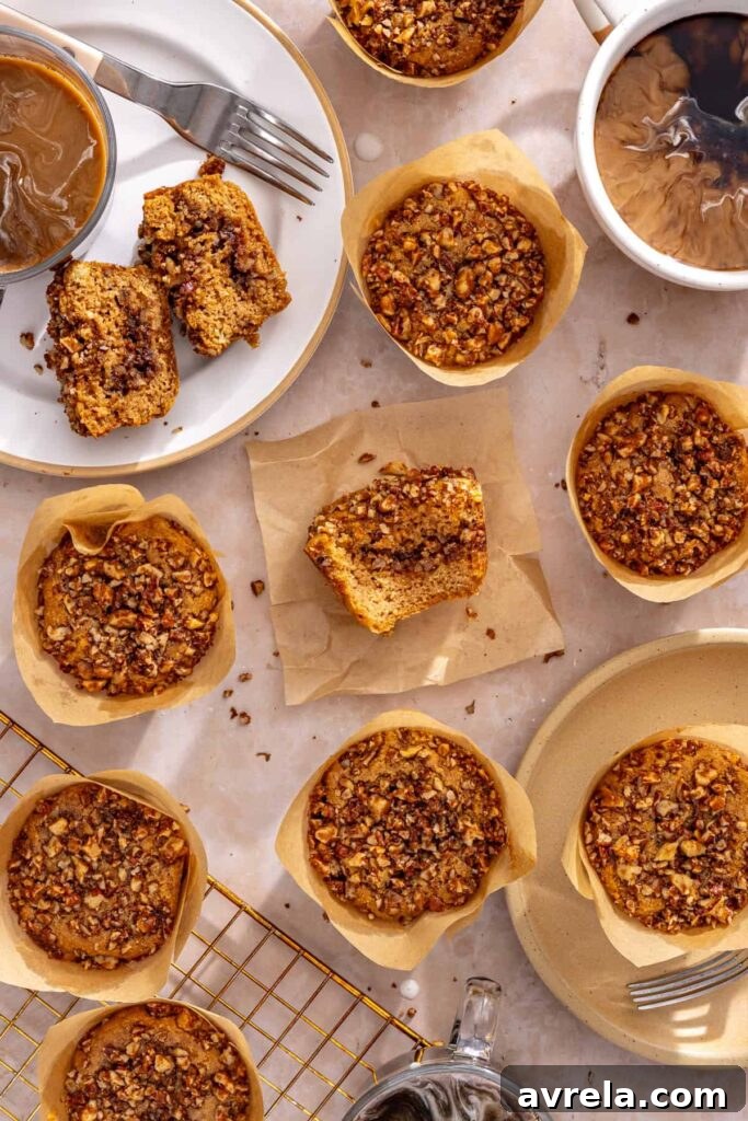 Homemade coffee cake muffins served with coffee on a table with cooling rack