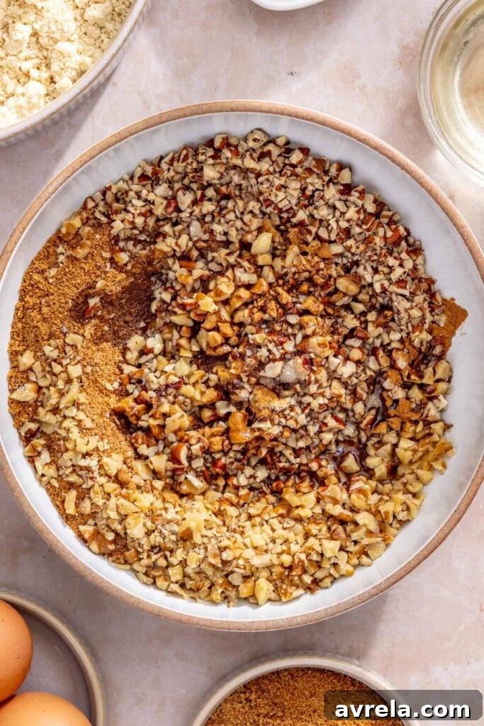 Bowl of cinnamon nut streusel topping being mixed for homemade coffee cake muffins