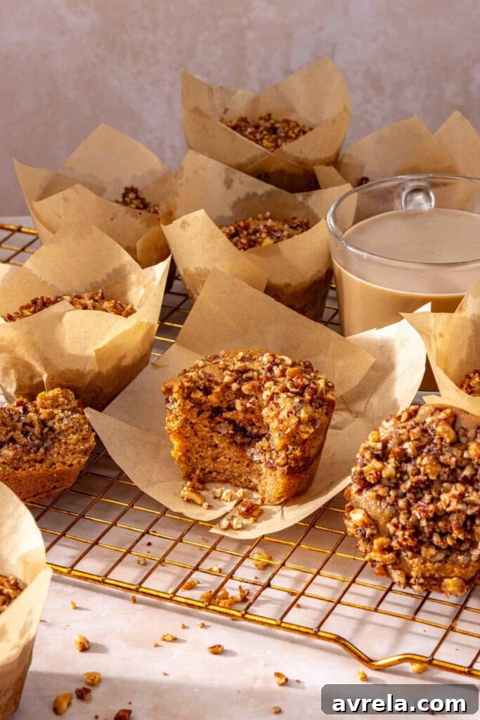 Gluten-free coffee cake muffins arranged on cooling rack with coffee