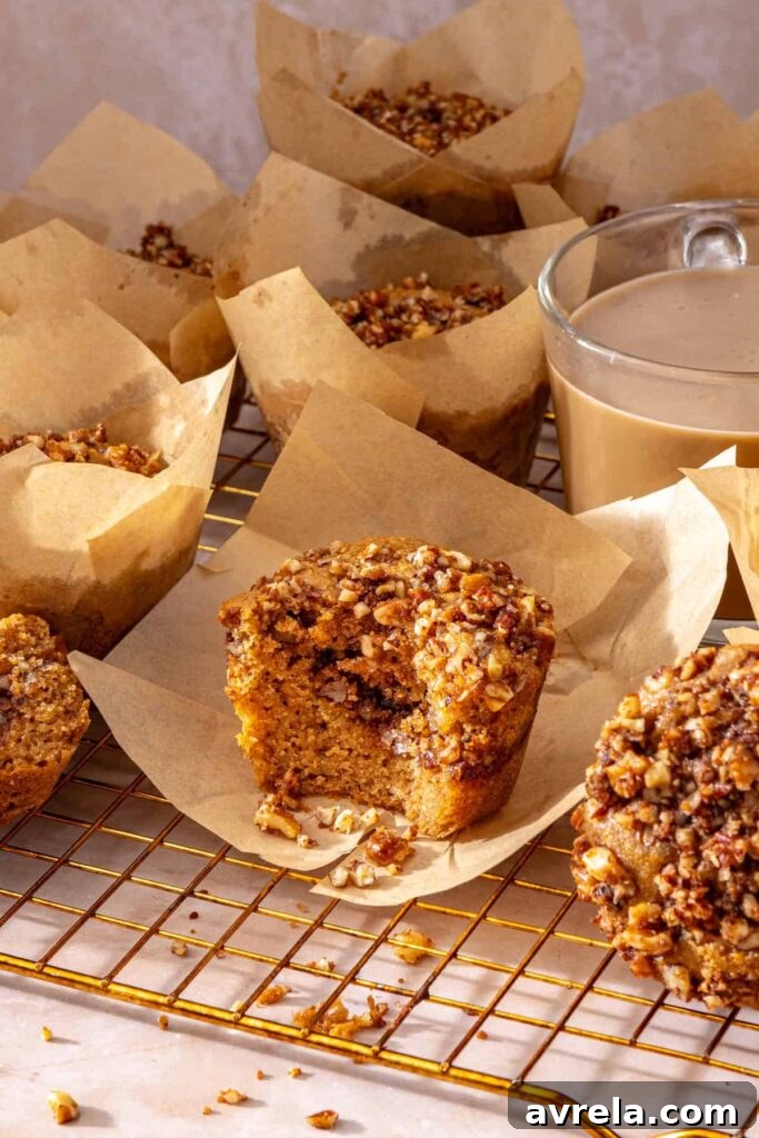 Fresh coffee cake muffin in parchment liner on cooling rack