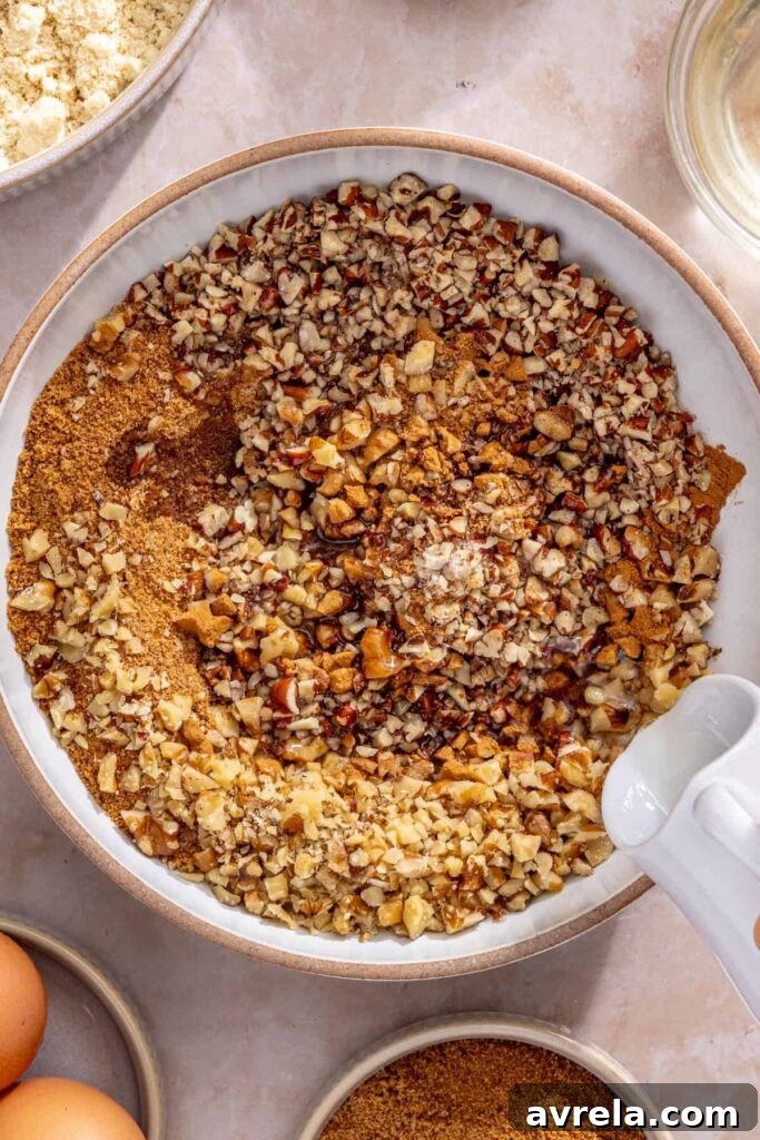 Mixing pecans, walnuts, coconut sugar and spices to make streusel topping for coffee cake muffins