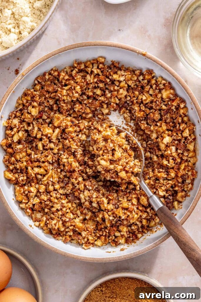 Preparing crunchy streusel topping with pecans and walnuts for coffee cake muffins