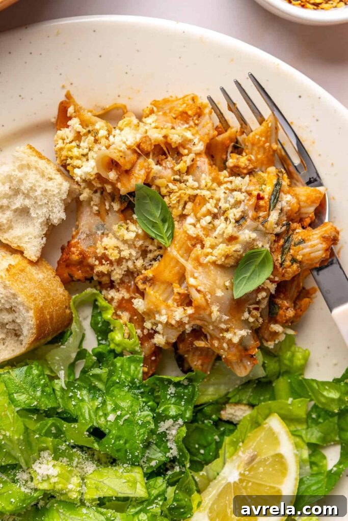 6 Easy Gluten-Free Pasta Recipes for Healthy, Delicious Meals 7 Easy baked ziti served on a plate with side salad and toasted baguette